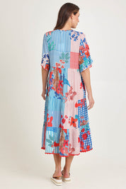 Model Madeline wearing size S of the Wymara Midi Dress in colour Print, from the back