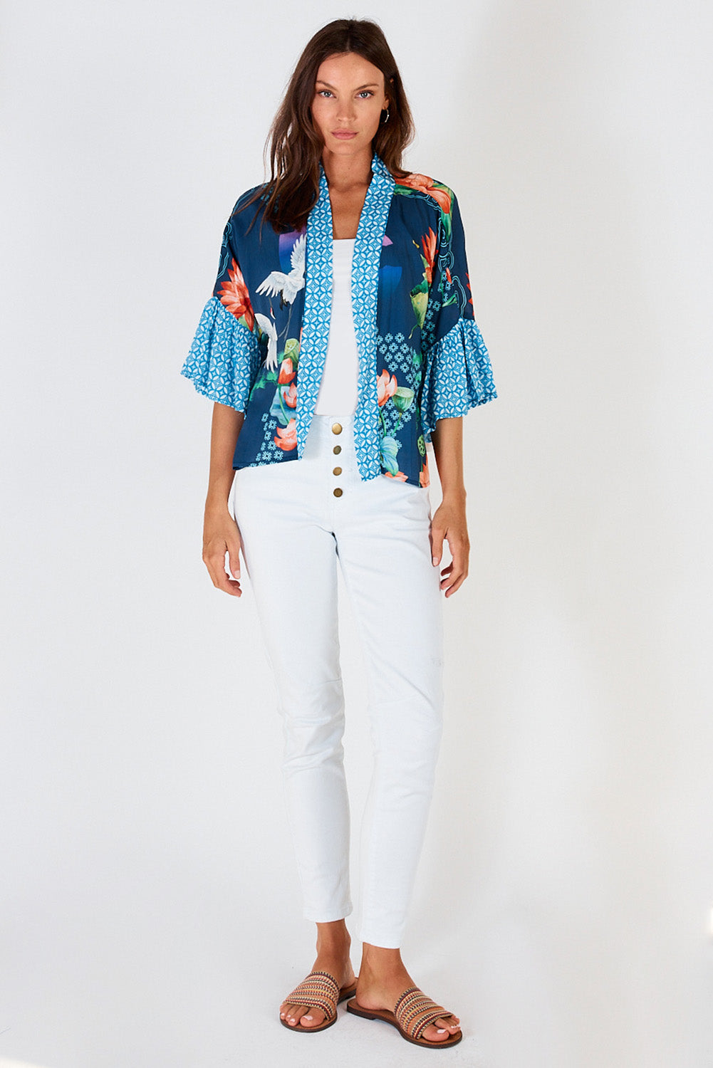 A model wearing the Yoshiko Bolero Jacket in colour Blue (Blue), from the front, showing the whole outfit
