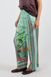 Model Genericm wearing size sample of the Zilara Pant – Mist in colour Mist, from an angle