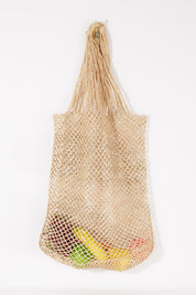 A model wearing size OneSize of the Malala Bag in colour Natural, from the front, showing the whole outfit
