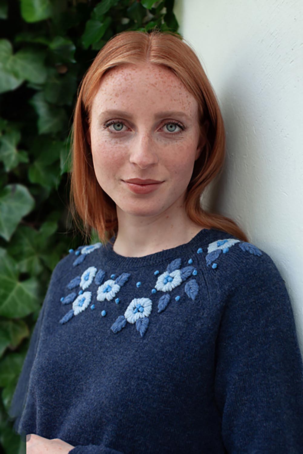 A model wearing the Bristol Sweater in colour Softblue (Blue), from the front, showing the whole outfit