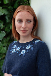 A model wearing the Bristol Sweater in colour Softblue (Blue), from the front, showing the whole outfit