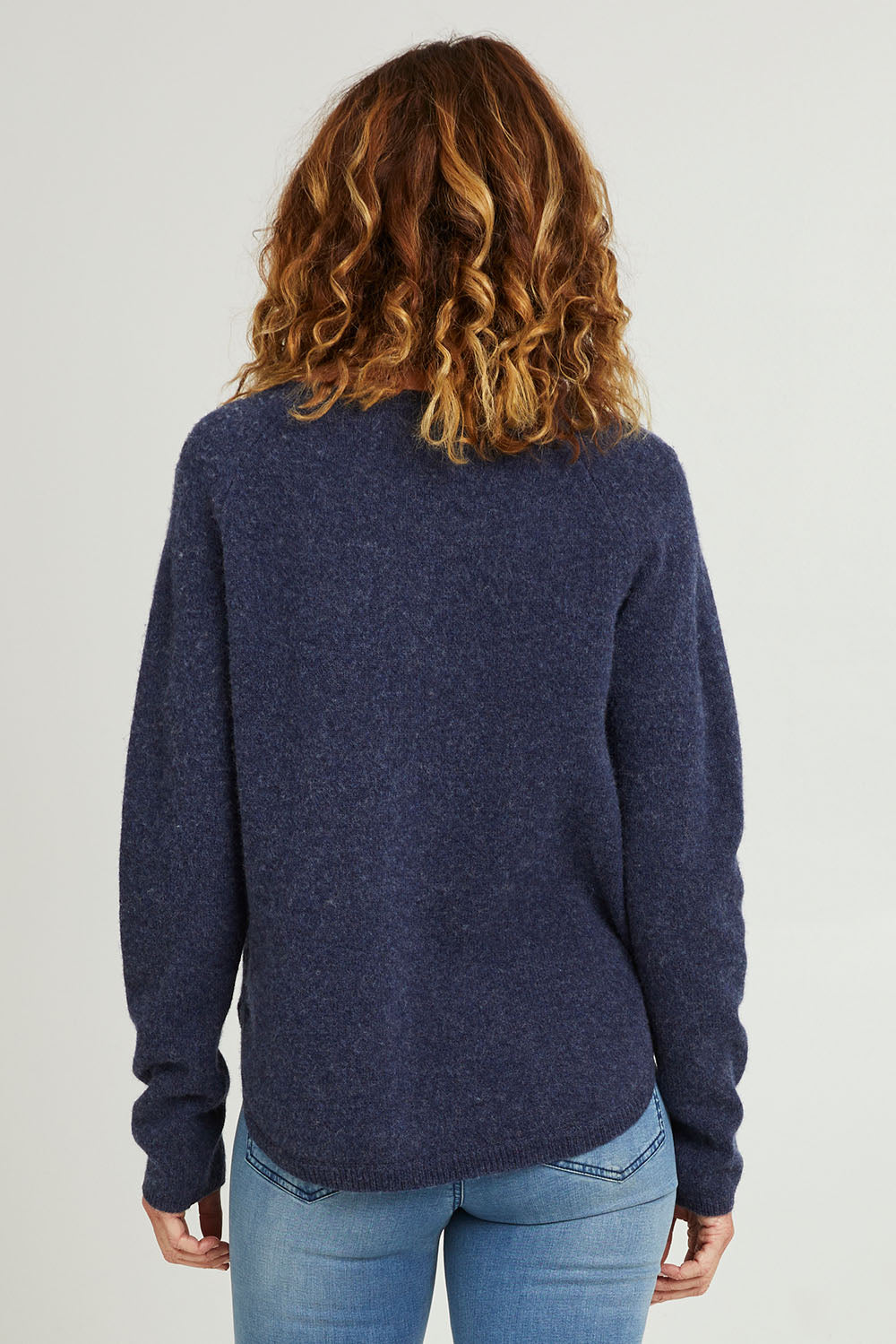 Model Luisa wearing size S of the Bristol Sweater in colour Softblue (Blue), from the back