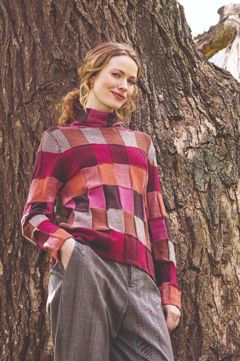 A model wearing the Lindi Organic Cotton Sweater in colour Spice (Pink), from the front, showing the whole outfit