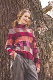A model wearing the Lindi Organic Cotton Sweater in colour Spice (Pink), from the front, showing the whole outfit