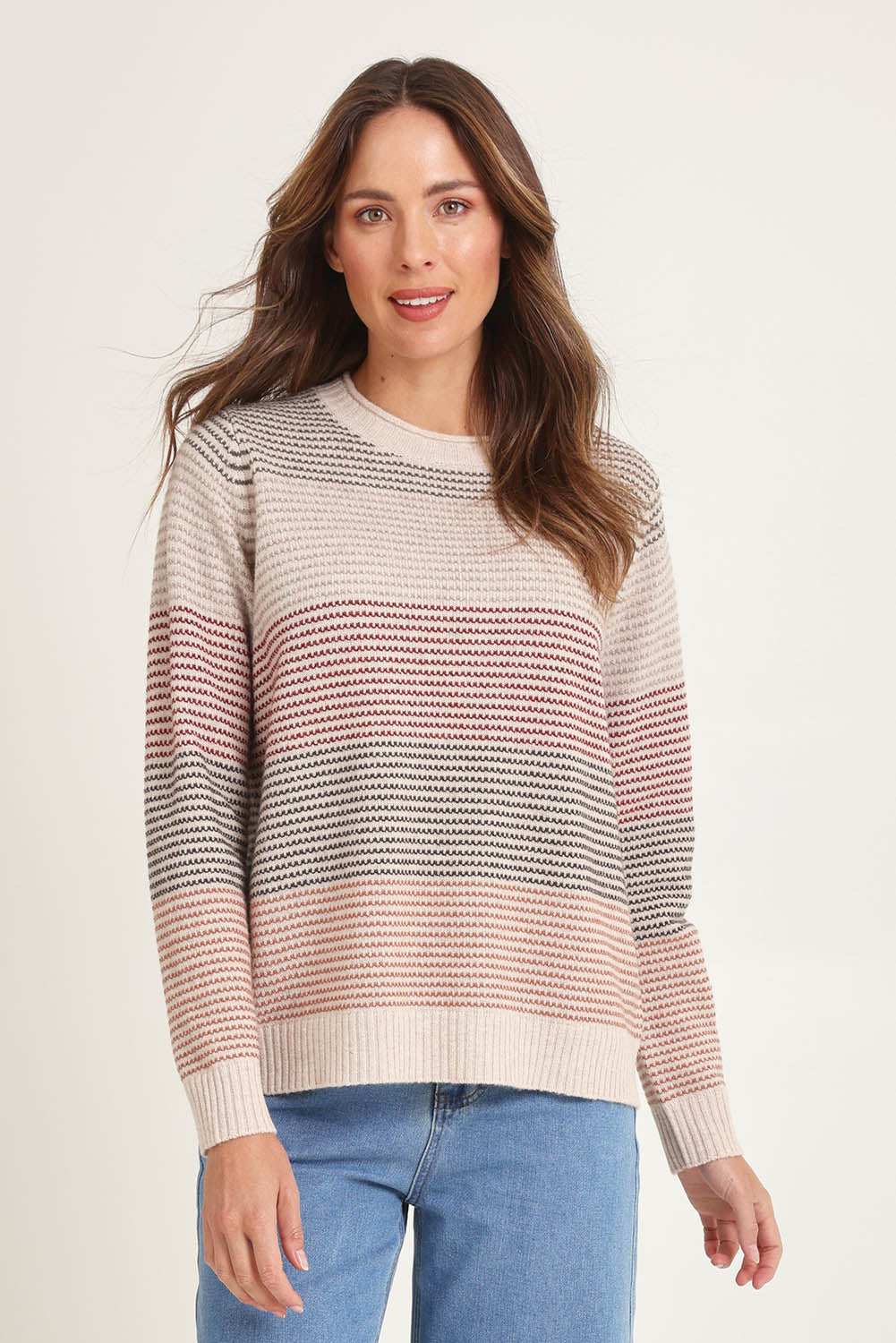 Model Madeline wearing size S of the Louise Lambswool Sweater in colour Oat, from the front, cropped image