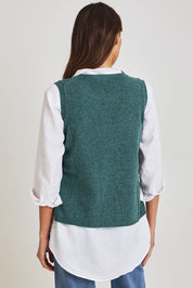 Model Madeline wearing size S of the Mitos Vest in colour Darksea (Green), from the back