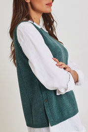 Model Madeline wearing size S of the Mitos Vest in colour Darksea (Green), from the front, cropped image