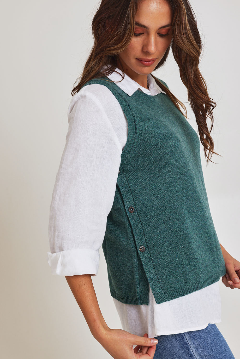 Model Madeline wearing size S of the Mitos Vest in colour Darksea (Green), from the front, cropped image