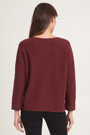 Model Madeline wearing size S of the Moriko Sweater in colour Spice, from the back