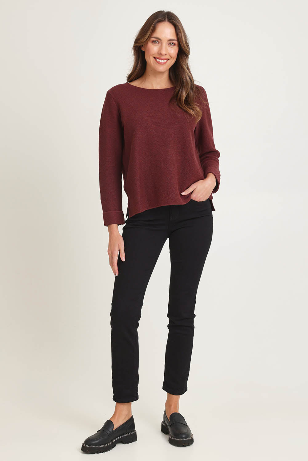 Model Madeline wearing size S of the Moriko Sweater in colour Spice, from the front, showing the whole outfit