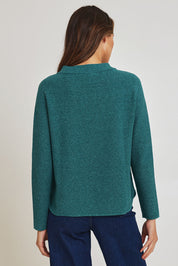 Model Madeline wearing size S of the Mosque Sweater in colour Sea (Green), from the back