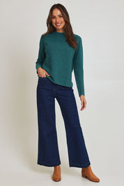 Model Madeline wearing size S of the Mosque Sweater in colour Sea (Green), from the front, showing the whole outfit
