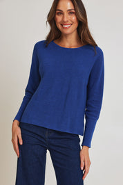 Model Madeline wearing size S of the Neria Organic Cotton Sweater in colour Blue (Blue), from the front, cropped image