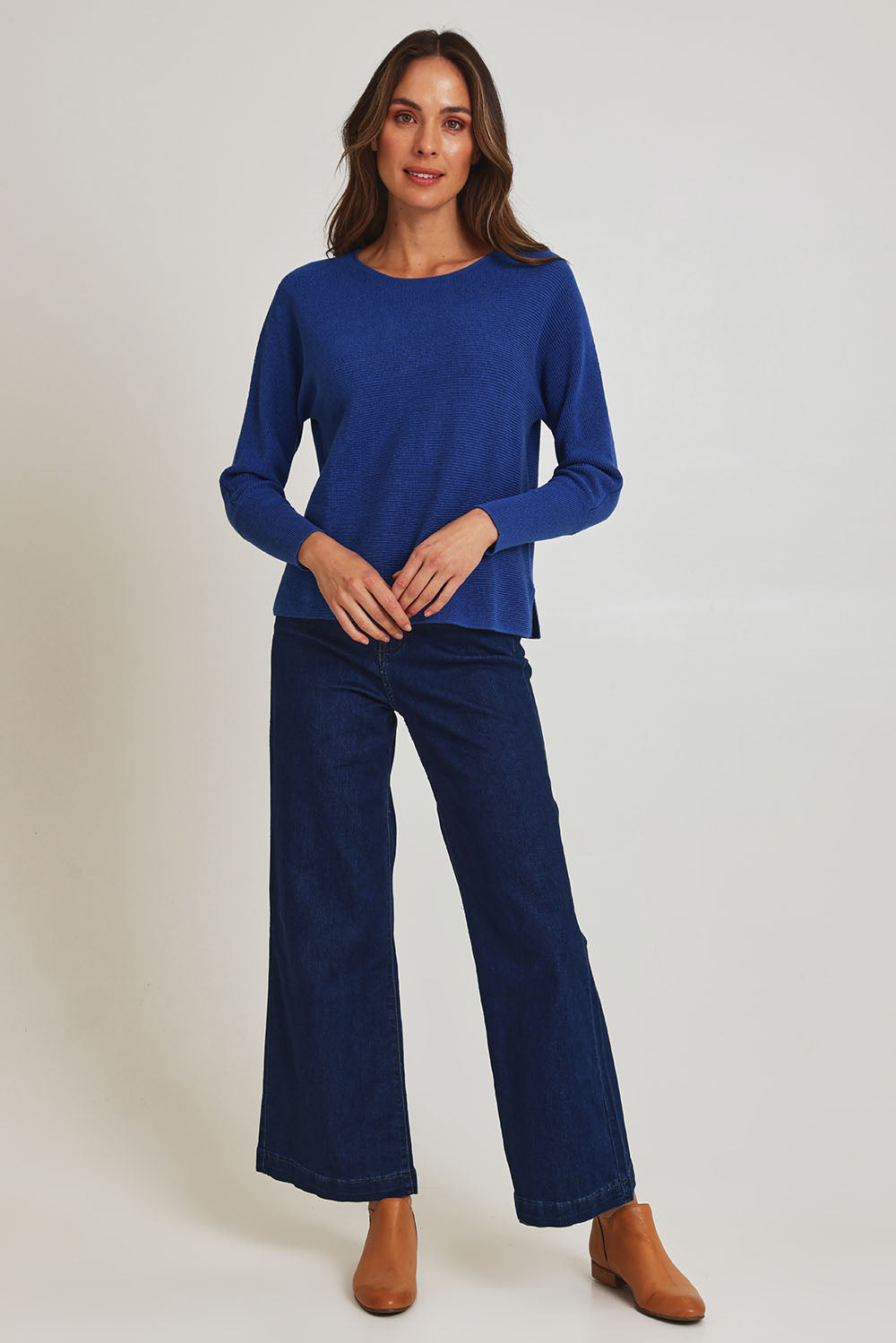 Model Madeline wearing size S of the Neria Organic Cotton Sweater in colour Blue (Blue), from the front, showing the whole outfit