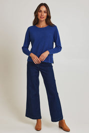 Model Madeline wearing size S of the Neria Organic Cotton Sweater in colour Blue (Blue), from the front, showing the whole outfit