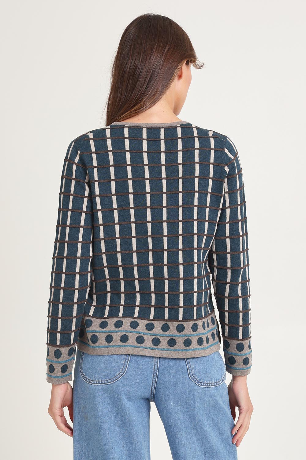 Model Madeline wearing size S of the Oda Organic Cotton Sweater in colour Darkaqua (Green), from the back