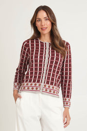 Model Madeline wearing size S of the Odette Organic Cotton Cardigan in colour Spice (Red), from the front, cropped image