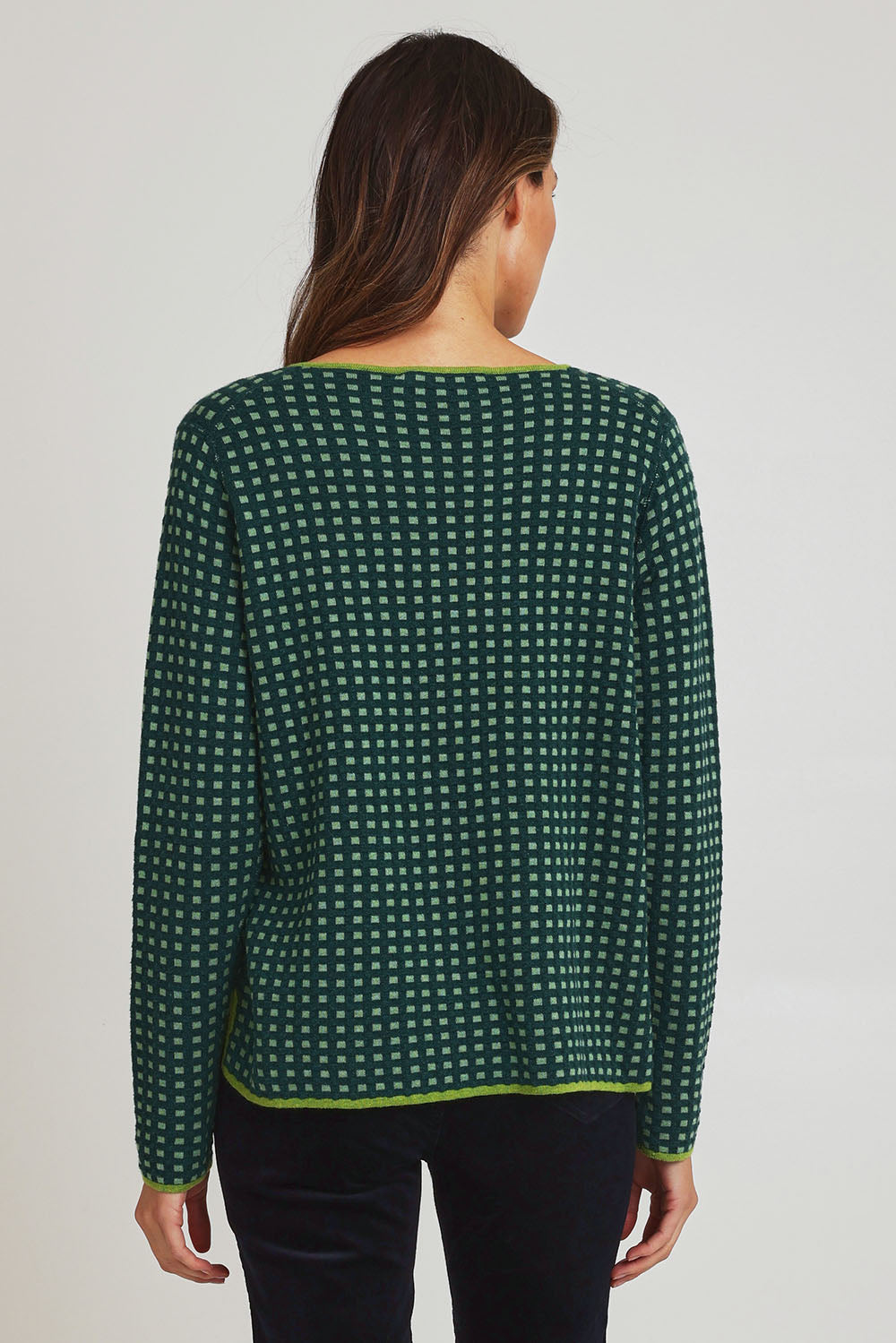 Model Madeline wearing size S of the Paprika Reversible Organic Cotton Sweater in colour Darkgreen (Green), from the back