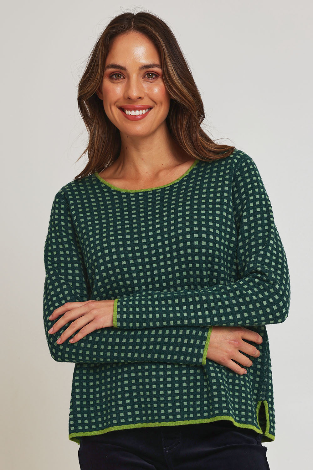 Model Madeline wearing size S of the Paprika Reversible Organic Cotton Sweater in colour Darkgreen (Green), from the front, cropped image