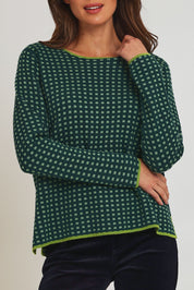 Model Madeline wearing size S of the Paprika Reversible Organic Cotton Sweater in colour Darkgreen (Green), from the front, cropped image