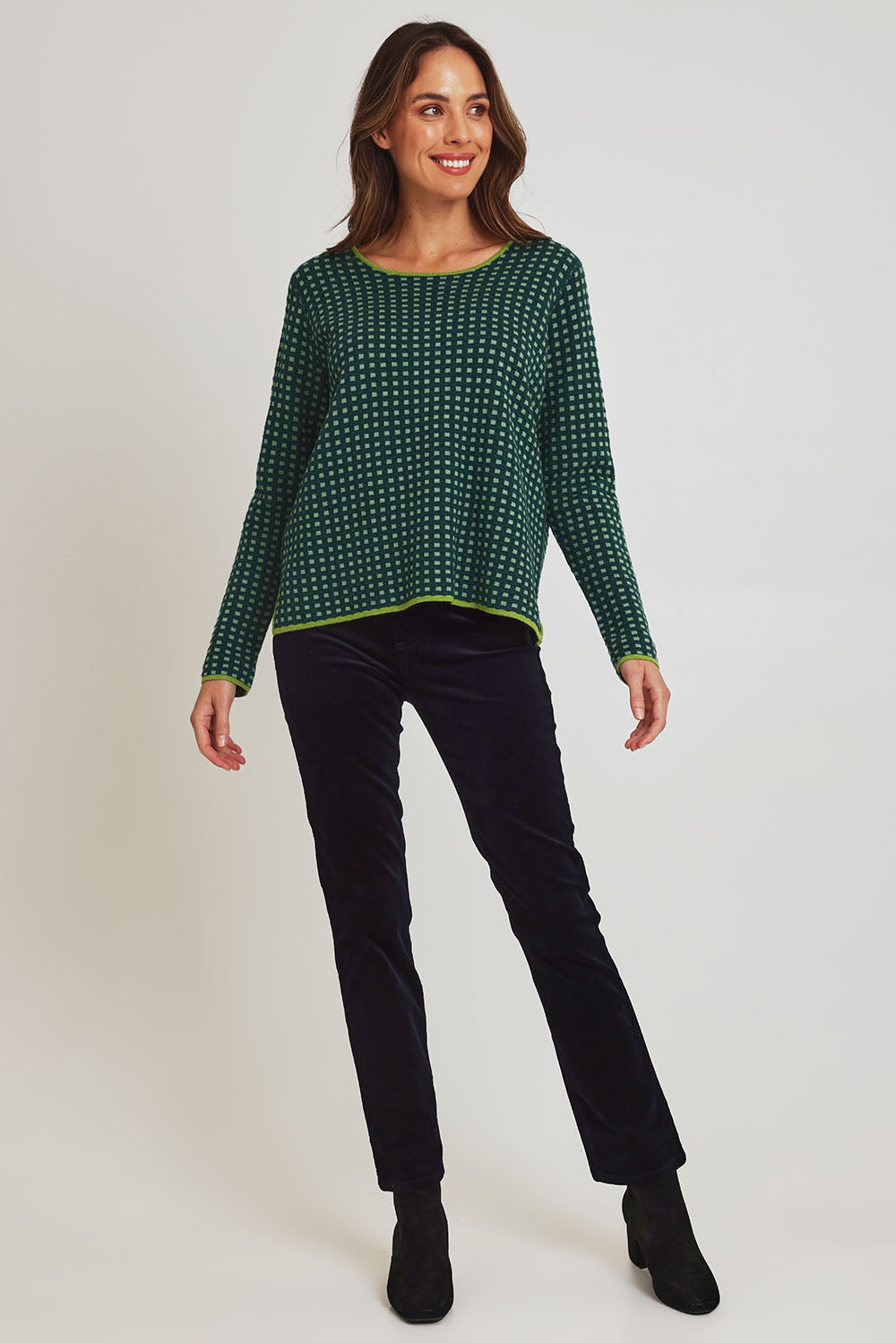 Model Madeline wearing size S of the Paprika Reversible Organic Cotton Sweater in colour Darkgreen (Green), from the front, showing the whole outfit