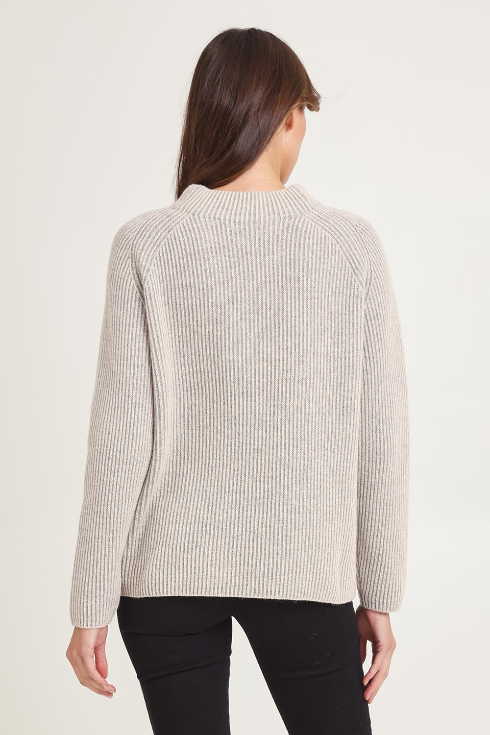 Model Madeline wearing size S of the Somers Lambswool Sweater in colour Oat, from the back