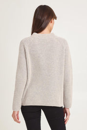 Model Madeline wearing size S of the Somers Lambswool Sweater in colour Oat, from the back