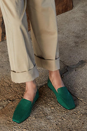 A model wearing the Aspen Nubuck Leather Slipper in colour Green (Green), from the front, showing the whole outfit