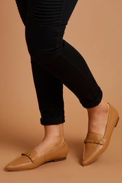 A model wearing size 38 of the Poplar Pointed Cross Leather Flat in colour Camel, from the front, showing the whole outfit