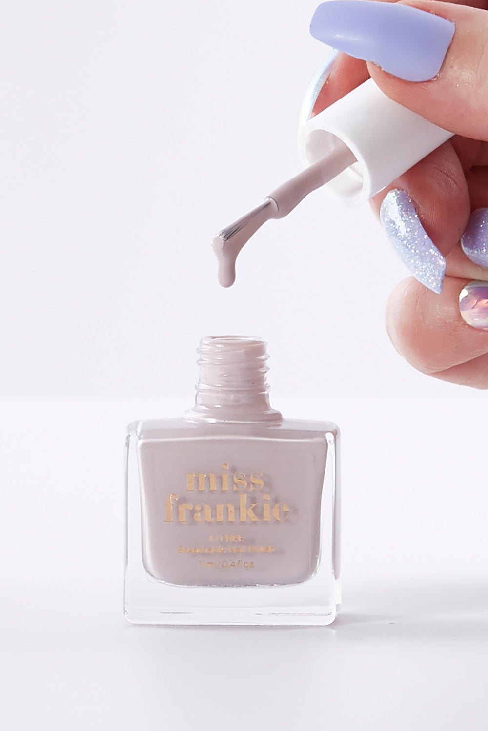 A model wearing size OneSize of the Chip Resistant Nail Polish in colour Champagne, from the front, showing the whole outfit