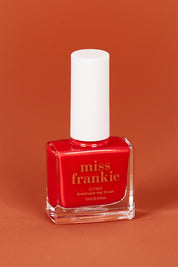 A model wearing size OneSize of the Chip Resistant Nail Polish in colour Heartsraci (Red), from the front, showing the whole outfit