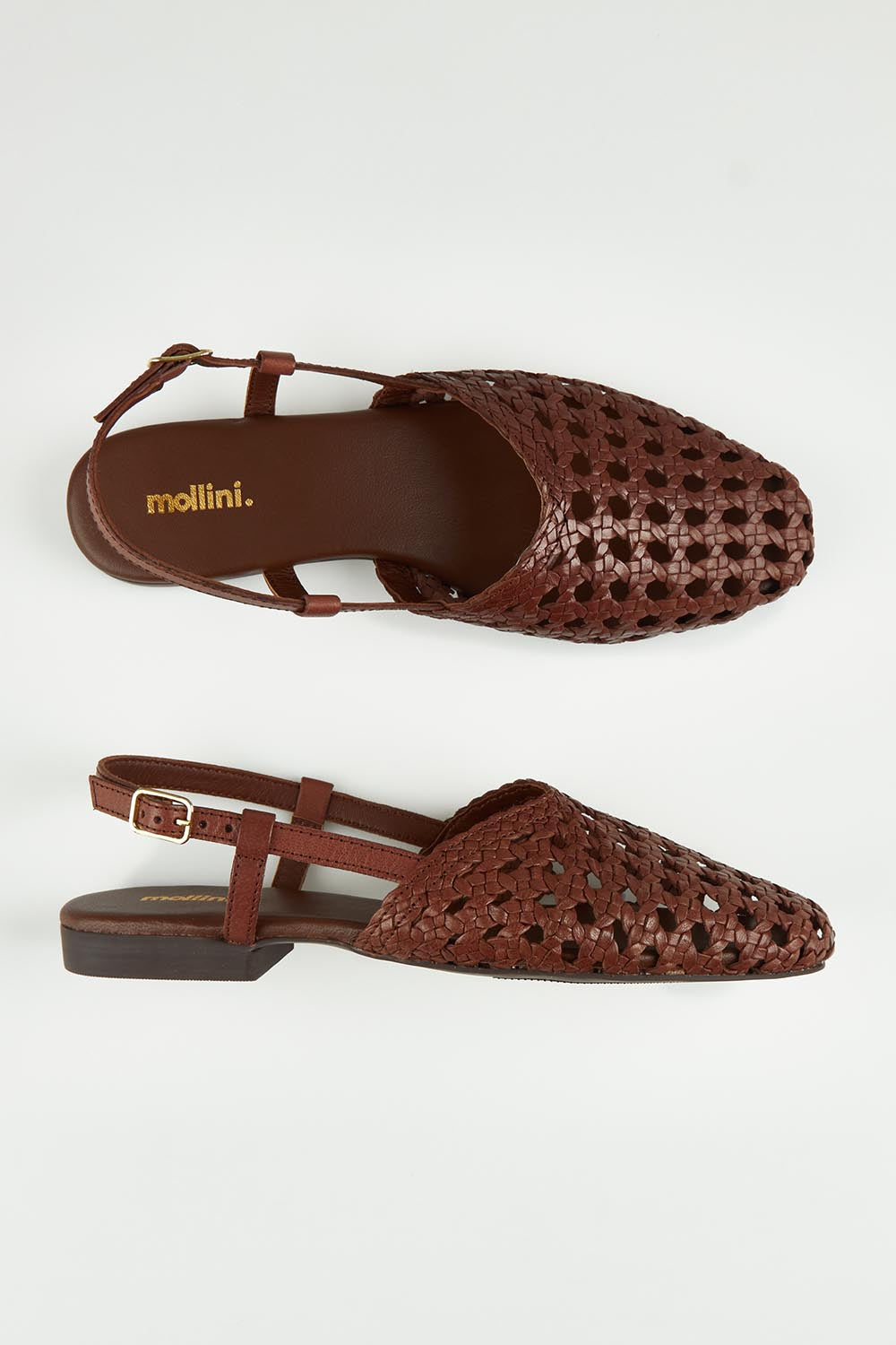 A model wearing size 37 of the Drasa Leather Woven Flat Heel in colour Chocolate, from the front, showing the whole outfit