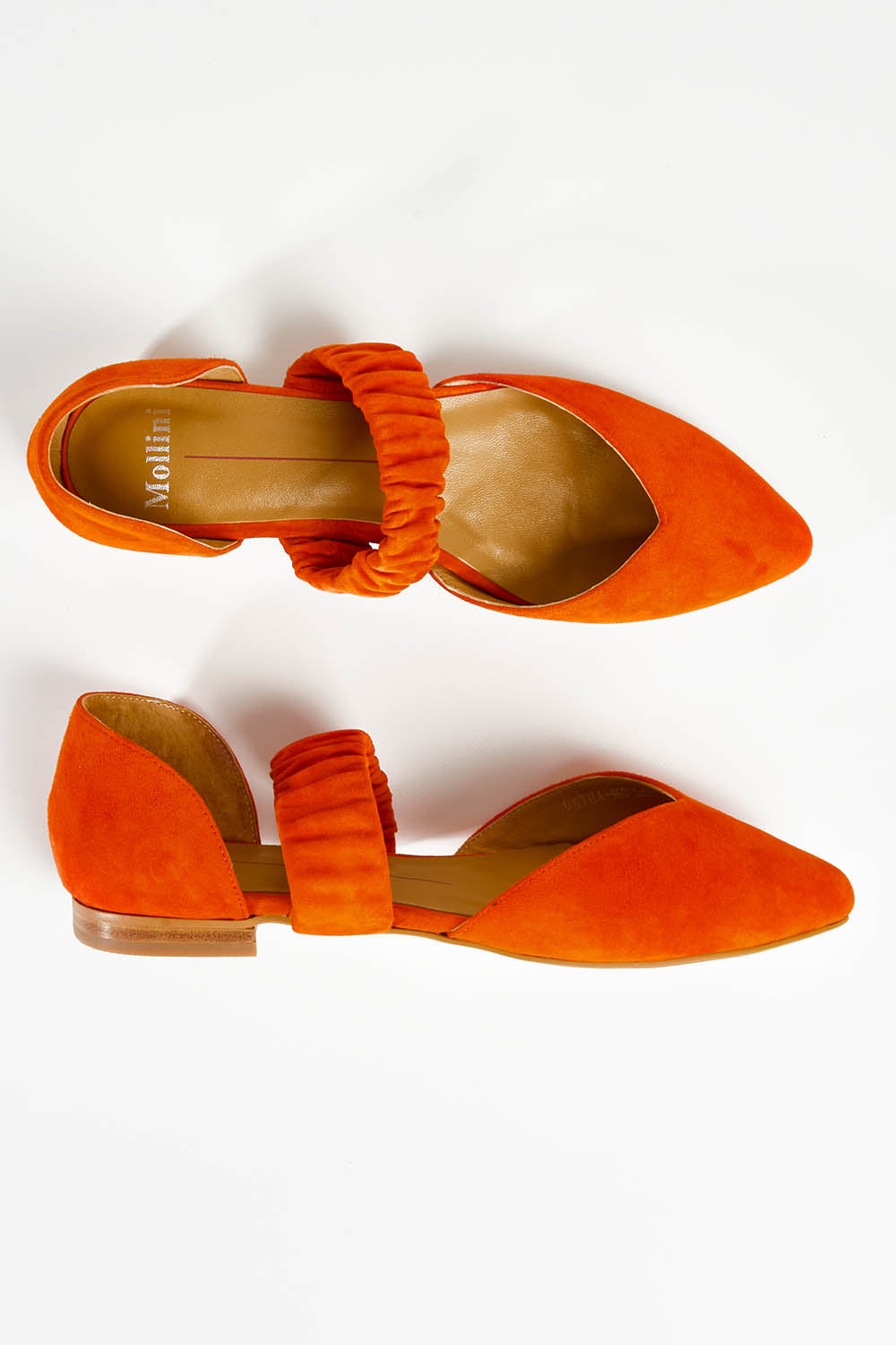 A model wearing size 37 of the Gatha Suede Flat in colour Orange, from the front, showing the whole outfit