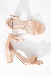 A model wearing size 36 of the Gessie Heel in colour Nude, from the front, showing the whole outfit