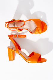 A model wearing size 37 of the Grayce Leather Heel in colour Orange, from the front, showing the whole outfit