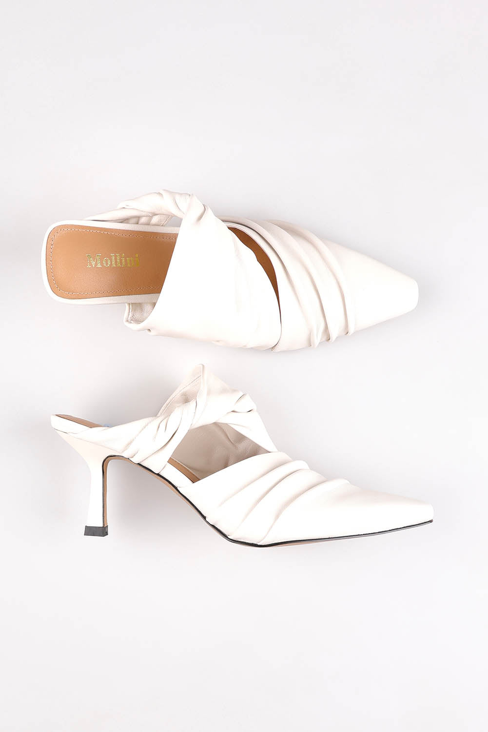 A model wearing size 37 of the Merly Leather Mule Heel in colour White (White), from the front, showing the whole outfit