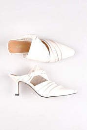 A model wearing size 37 of the Merly Leather Mule Heel in colour White (White), from the front, showing the whole outfit