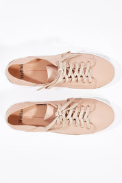 A model wearing size 36 of the Oskher Leather Sneaker in colour DarkNude (Pink), from the front, showing the whole outfit