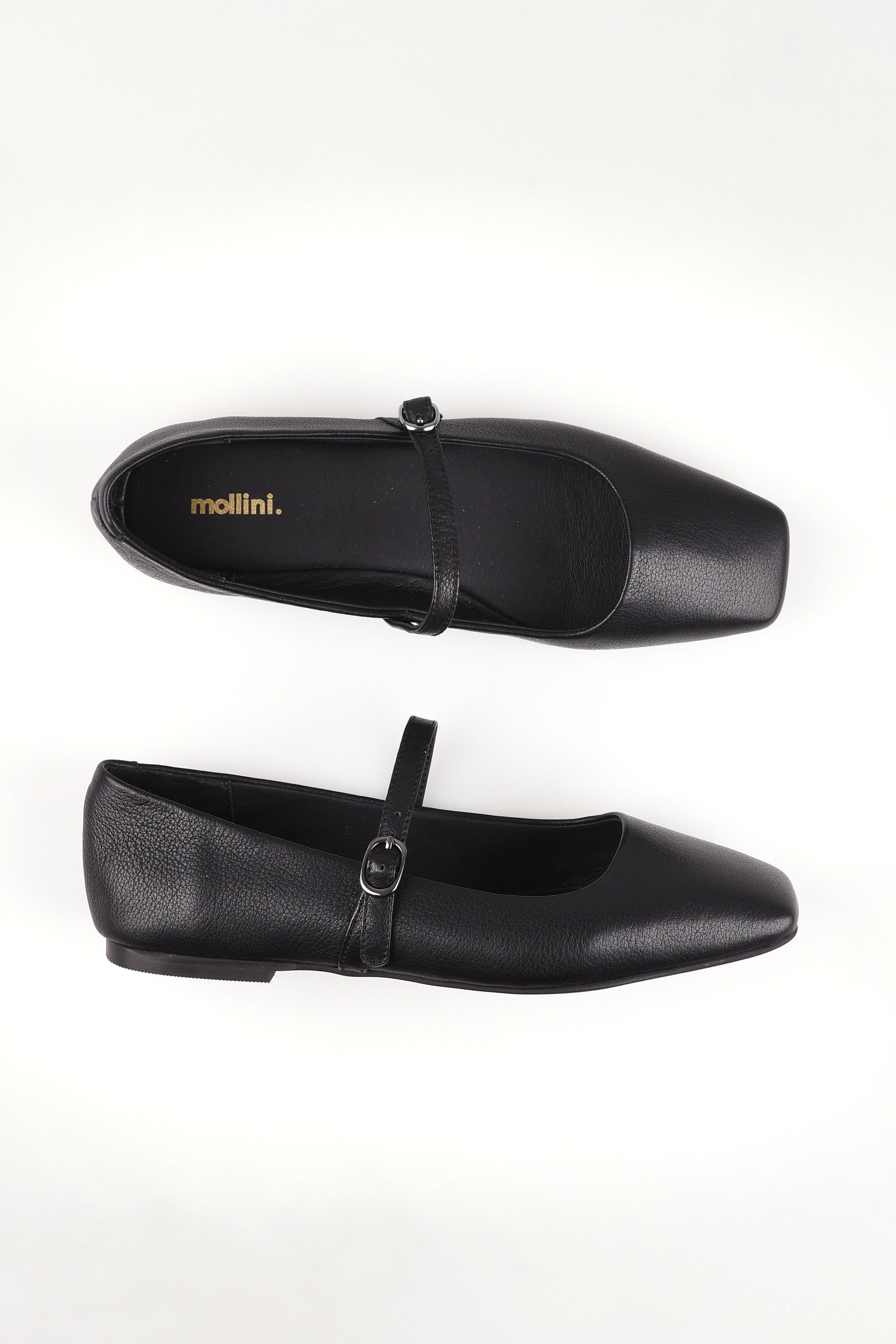 A model wearing size 37 of the Tokena Leather Flat in colour Blackleath (Black), from the front, showing the whole outfit