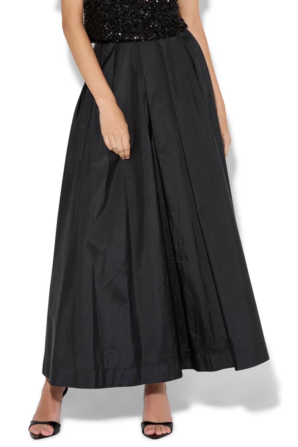 A model wearing the Lux Maxi Skirt in colour Black (Black), from the front, cropped image