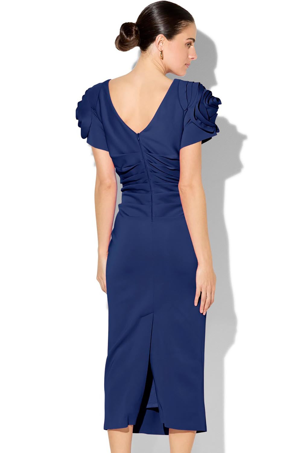 A model wearing the Monelli Rosette Sleeve Dress in colour Navy (Blue), from the back
