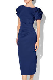 A model wearing the Monelli Rosette Sleeve Dress in colour Navy (Blue), from the front, cropped image