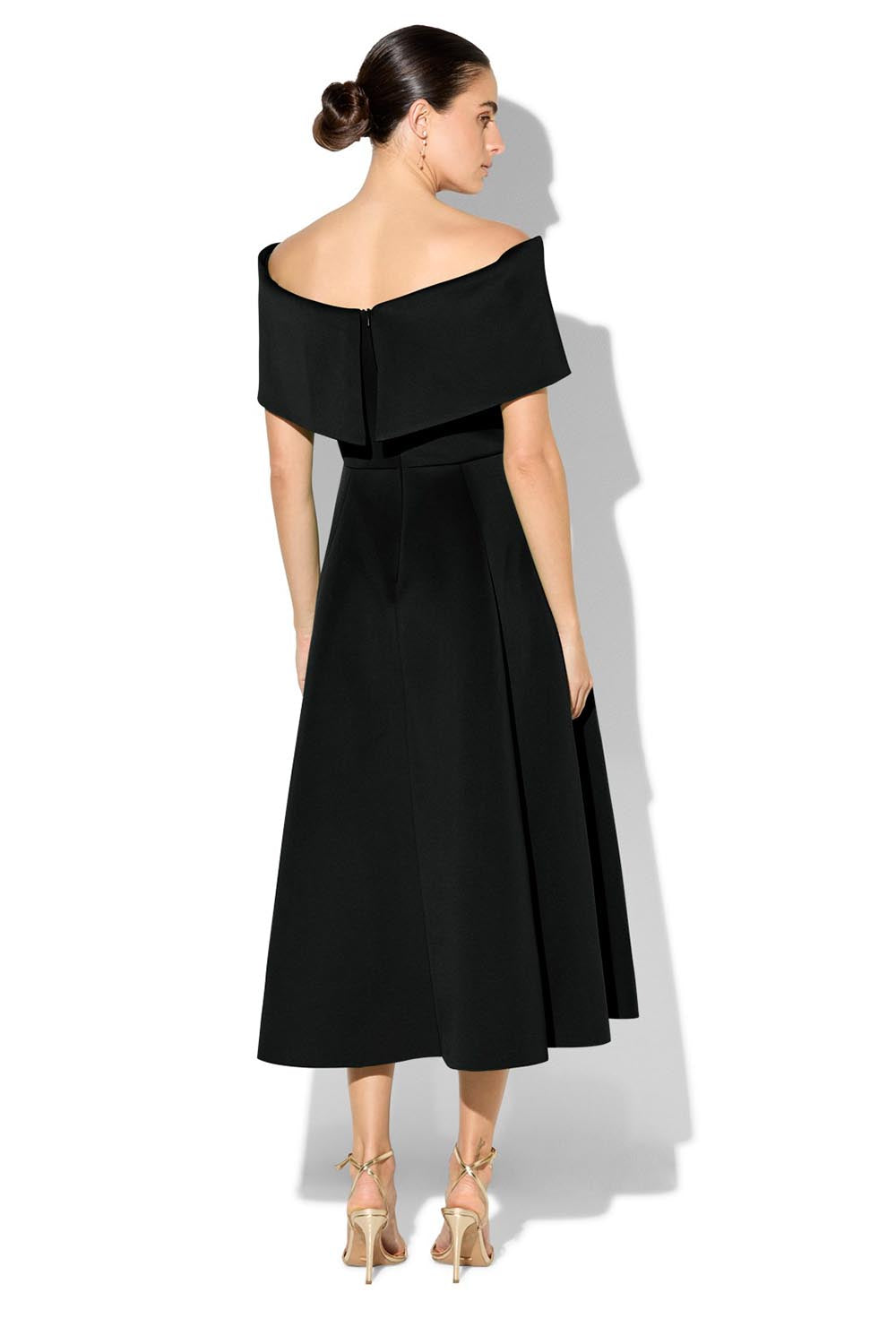A model wearing the Rowan Cocktail Dress in colour Black (Black), from the back