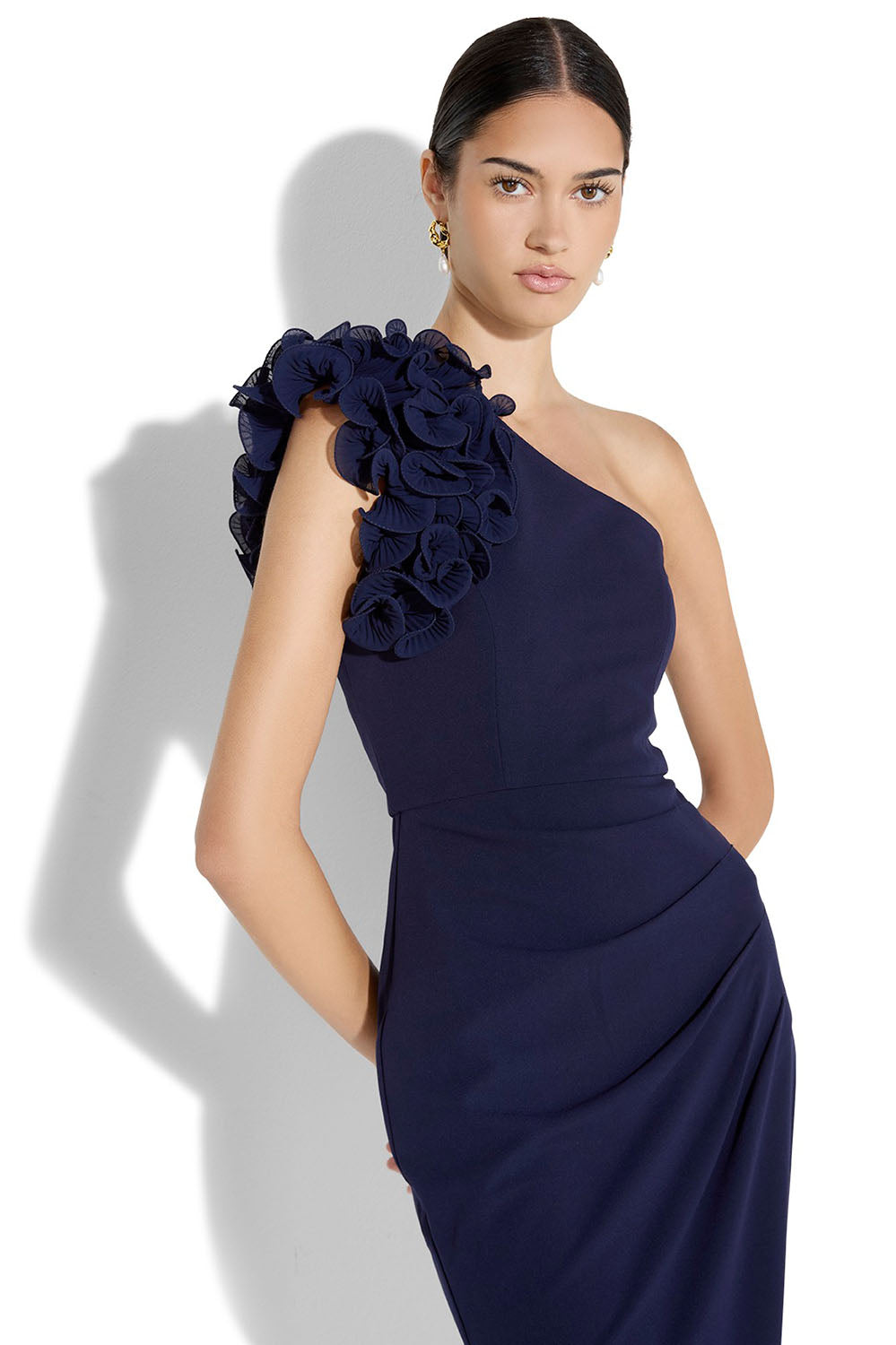 A model wearing the Elle One Shoulder Gown in colour Navy (Blue), from the front, cropped image