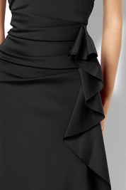 A model wearing the Sebastian Halter Gown in colour Black (Black), from the front, cropped image