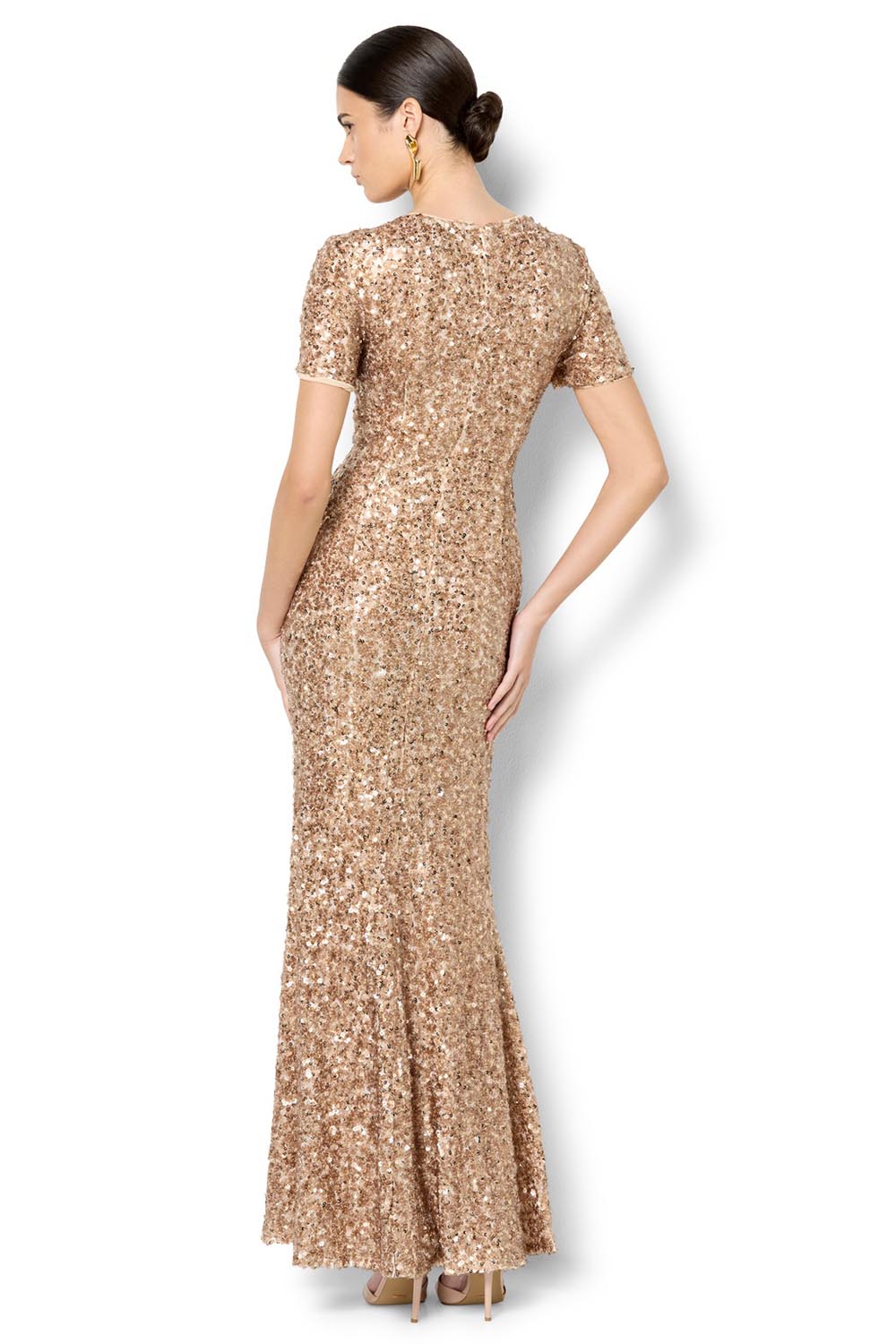 A model wearing the Colette Sequin Gown in colour Mink, from the back