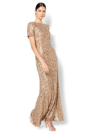 A model wearing the Colette Sequin Gown in colour Mink, from the front, showing the whole outfit
