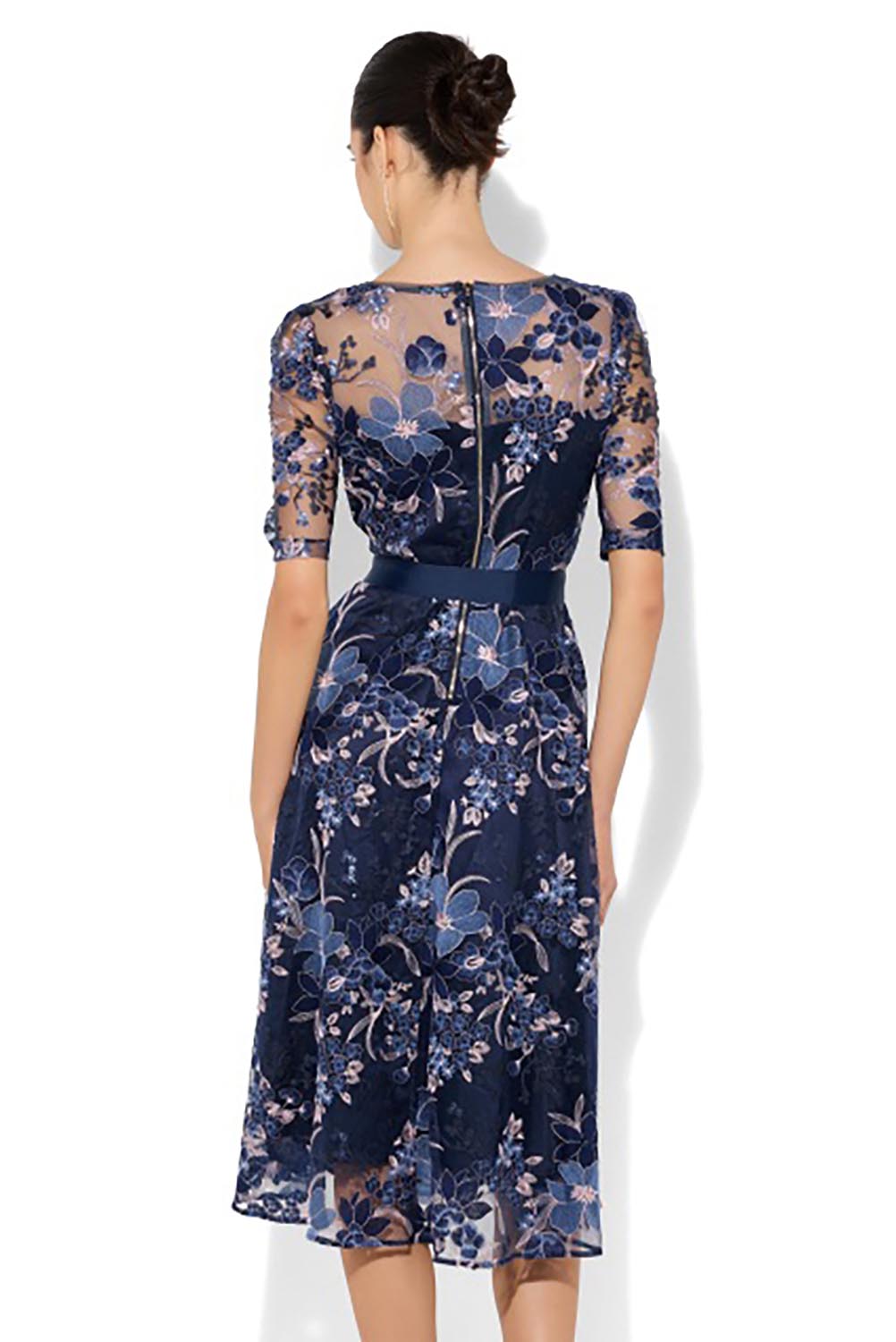 A model wearing the Loren Lace Midi Dress in colour Navypink (Blue), from the back