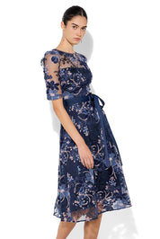 A model wearing the Loren Lace Midi Dress in colour Navypink (Blue), from the front, cropped image